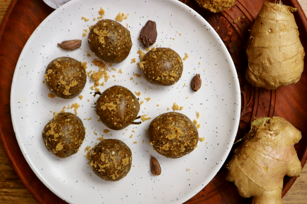 chai spice energy balls top view with ginger pieces 