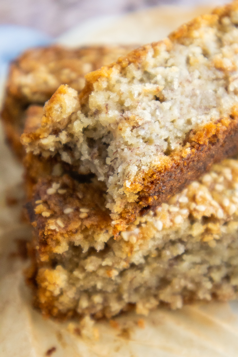 Vegan Sesame Tahini Banana Bread close up with a bite taken out